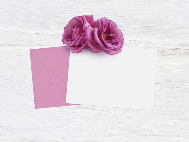 Photo fête des mères anniversaire ou scène de maquette de mariage avec enveloppe carte vierge et fleurs roses grunge fond blanc plat laïcs image vue de dessus