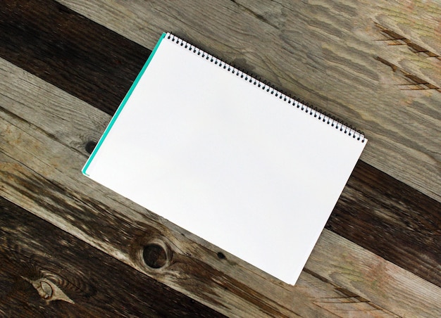 Feuille de papier blanc sur la table en bois à l'extérieur