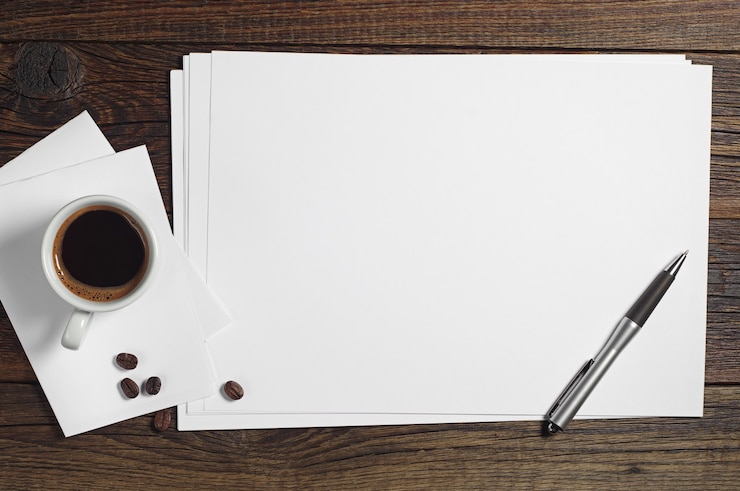 Photo feuille de papier vierge et une tasse de café sur une table en bois foncé, vue de dessus