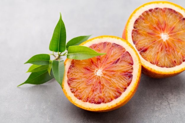 Figues entières et une figue coupée en deux sur une table grise.