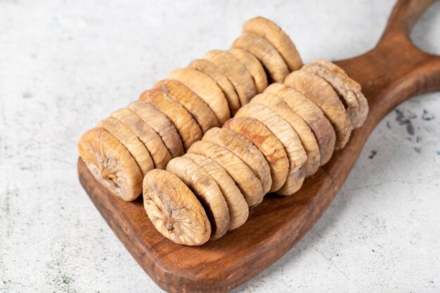 Figues séchées sur fond de pierre Figues sèches au soleil spéciales sur une planche de service en bois Aliments diététiques en gros plan