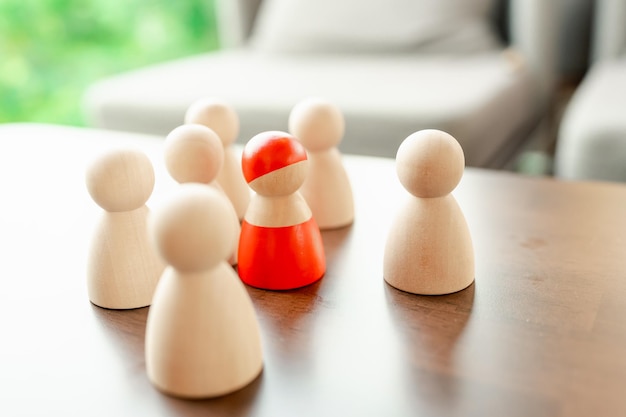 Photo une figure en bois rouge debout avec une équipe pour influencer et autonomiser