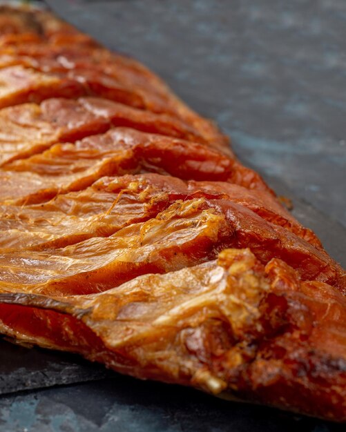 Filet de poisson fumé à froid sur fond sombre