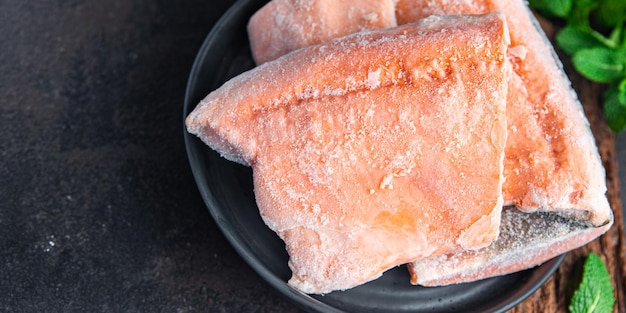 Filet de poisson rouge congelé saumon ou omble chevalier repas semi-fini frais collation diététique sur la table