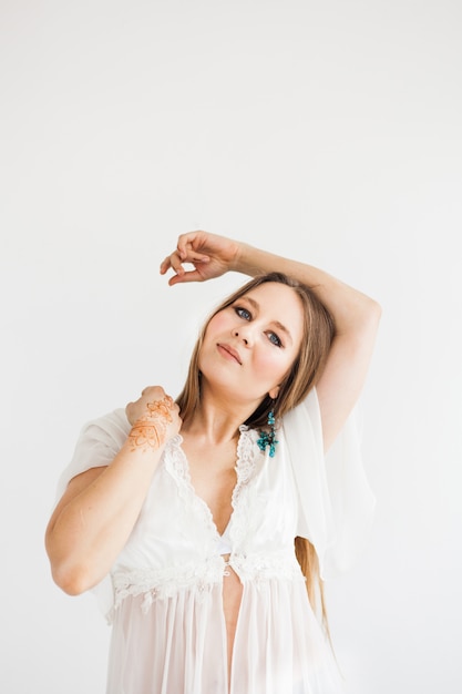 Fille d'apparence européenne, dessin au henné sur les mains, mahendi, fille en vêtements légers, yoga, développement spirituel