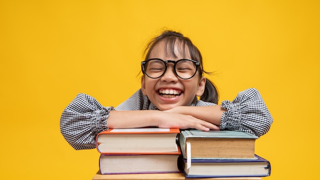 Fille asiatique thaïlandaise avec pile de livre