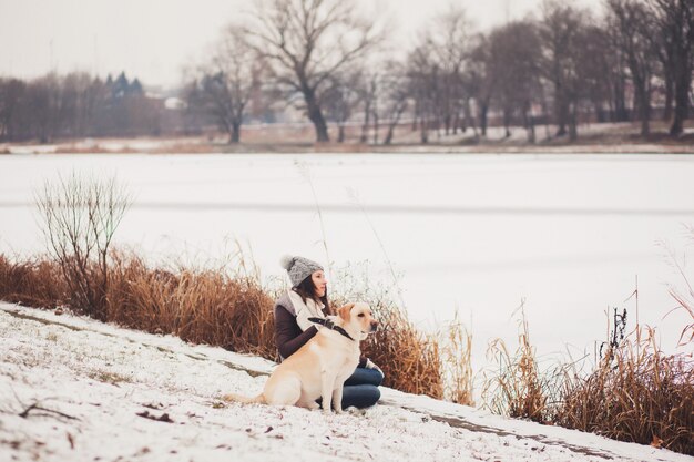 Fille assise avec son chien dans le parc