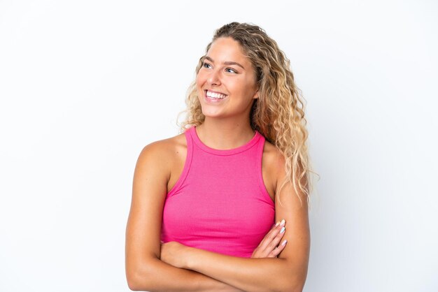 Fille aux cheveux bouclés isolé sur fond blanc heureux et souriant