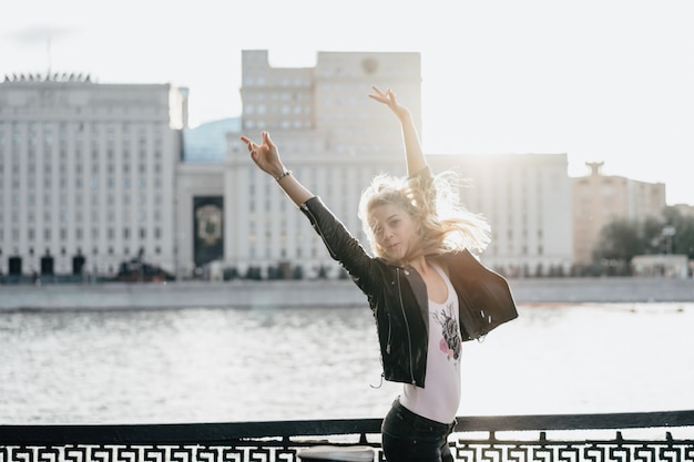 Photo fille aux cheveux longs sur le fond de la ville.