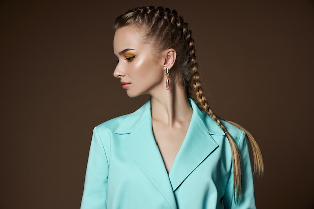 Fille avec de belles boucles d'oreilles dans ses oreilles, un portrait de beauté d'une femme avec des bijoux. Peau parfaitement lisse