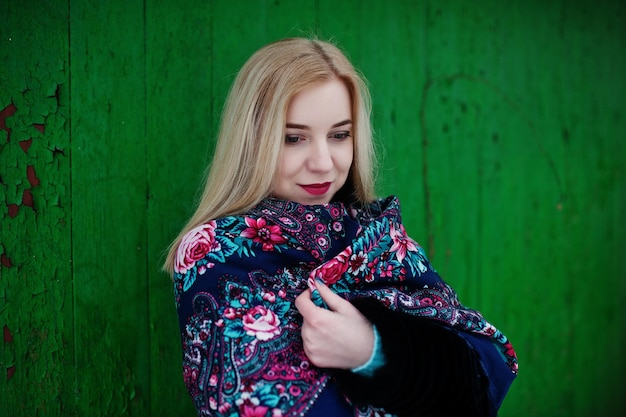 Fille blonde avec écharpe brodée à la main posée au jour d'hiver. Mouchoir de femme.