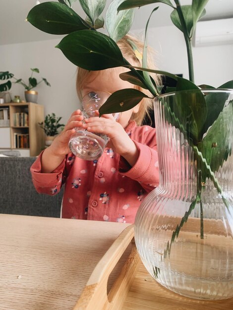 Photo une fille boit de l'eau dans un verre.