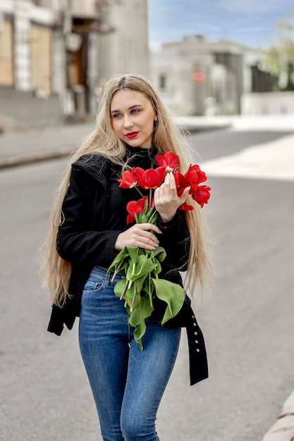Fille avec un bouquet de tulipes rouges