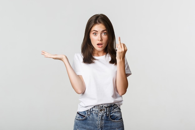 Fille brune confuse et énervée se disputant à propos du mariage, montrant le doigt sans bague.