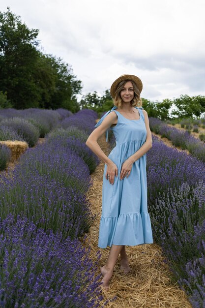 Une fille avec un chapeau dans un champ de lavande