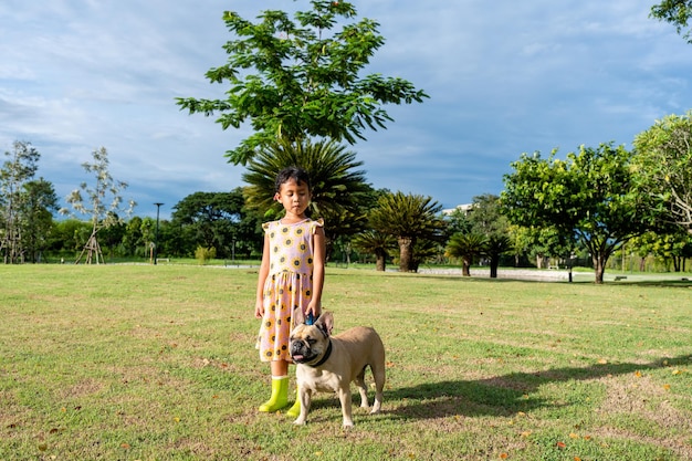 Une fille avec un chien dans un parc