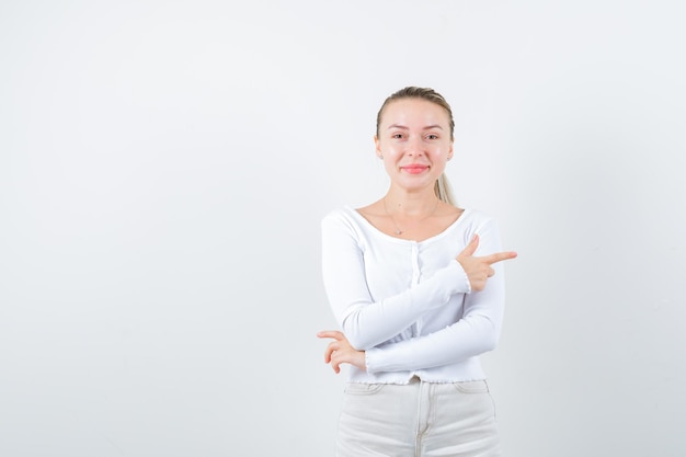 Fille de couleur claire montre son côté droit sur fond blanc