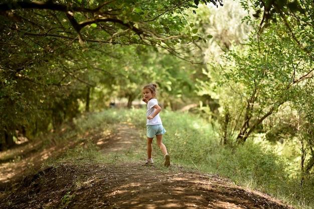 Une fille court sous les arbres