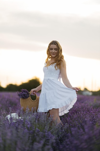 Fille dans un champ de lavande Femme dans un champ de fleurs de lavande au coucher du soleil dans une robe blanche France Provence