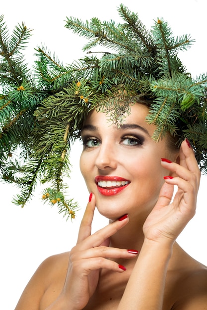 La fille dans une couronne de branches de sapin