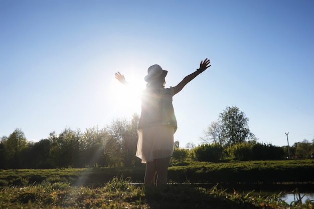 Fille dans le parc le soir d'une journée ensoleillée au printemps