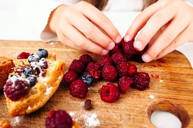 Fille de décoration de pâtisserie avec des baies