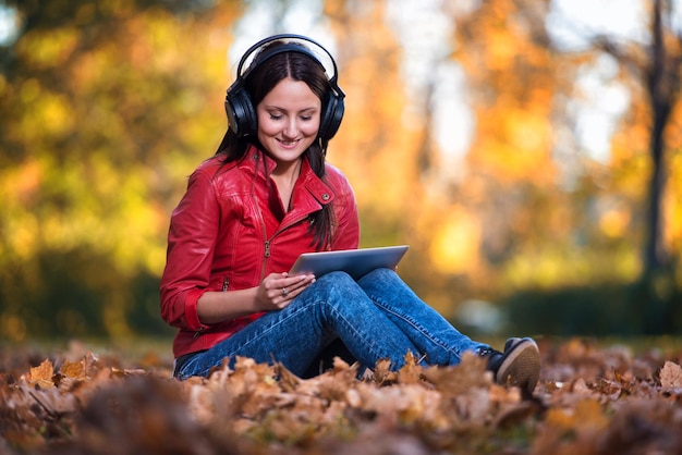 Fille écoutant de la musique sous le soleil d'automne