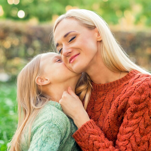 La fille embrasse sa jeune mère