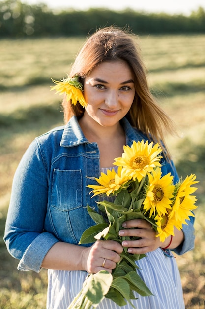 Fille enceinte dans les tournesols fille heureuse attendant le bébé