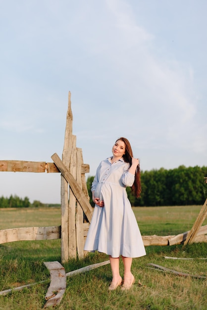 Photo fille enceinte en été à l'extérieur au soleil couchant