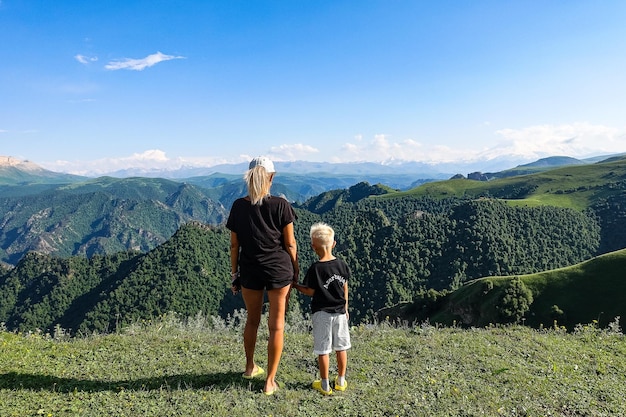 Une fille avec un enfant sur le fond des montagnes du Caucase près du tractus de JilaSu KabardinoBalkaria