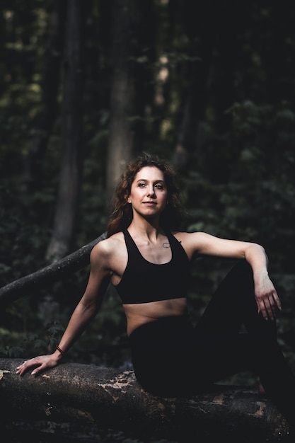 Fille faire du sport dans la forêt. Dans la position du lotus. Exercices, gymnastique, relaxation. Mode de vie sain.