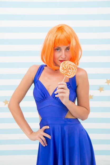 Fille folle avec sucette sucette magasin de bonbons publicité fille folle avec des cheveux orange élégants tenant une sucette sucrée goût coloré très gros bonbons voulez-vous un doux baiser