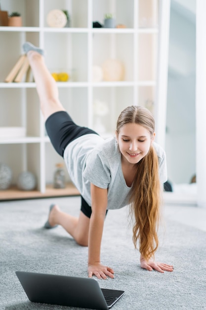 Fille de formation à domicile sport enfant en ligne avec ordinateur portable