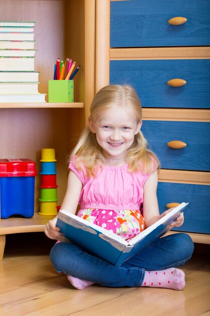 Fille lit un livre dans ta chambre