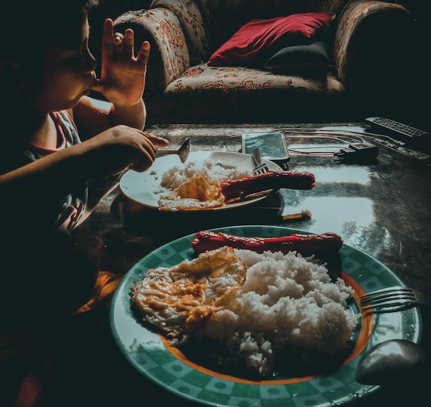 Photo une fille mangeant à la maison.