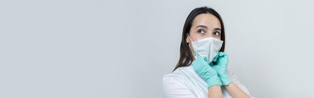 Une fille médecin portant des gants en latex et une blouse blanche se prépare pour les procédures.