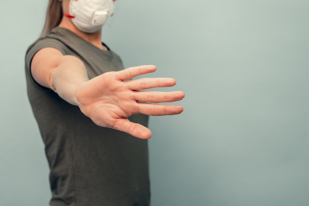 Une fille met un masque de protection. Protection respiratoire contre les coronavirus. Gardez la distance. Équipement de protection individuelle en cas de pandémie d'infection virale. Covid19.