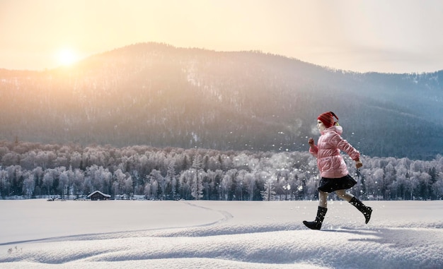 Une fille portant un chapeau laineux et des bottes wellington marche seule avec un paysage en arrière-plan. Technique mixte