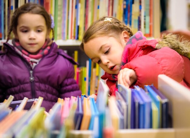 Photo une fille qui choisit un livre à la bibliothèque