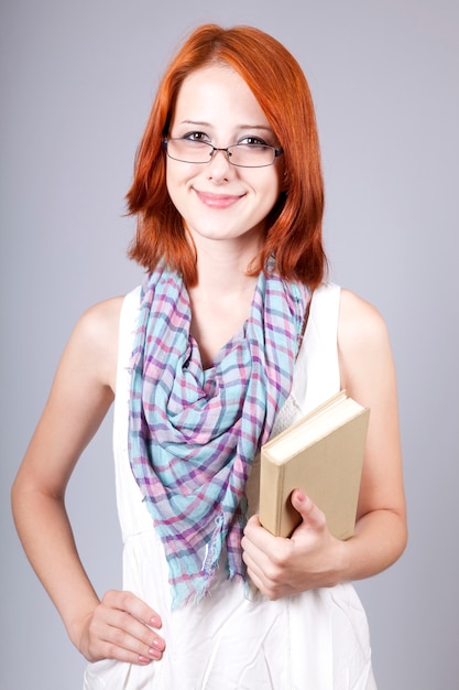 Fille rousse garder le livre en main.