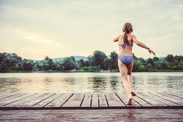 Fille sautant dans l'eau