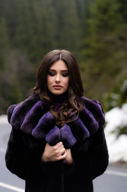 Fille souriant à la caméra sur les bois d'hiver