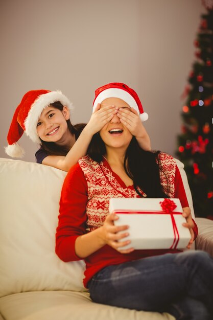 Fille surprenant sa mère avec un cadeau de Noël