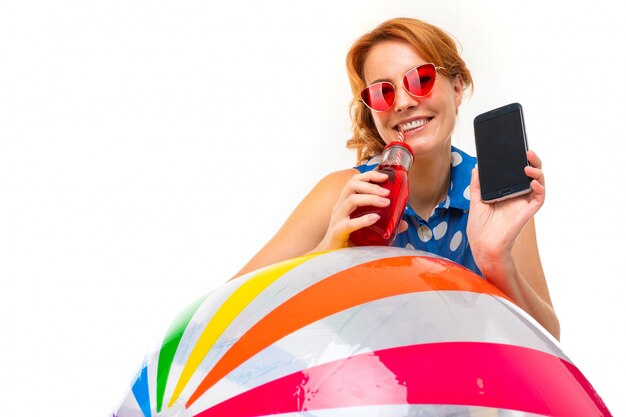 fille avec un téléphone avec une maquette sur un mur blanc