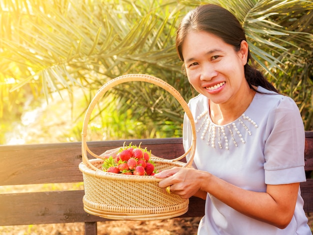 Fille tenant un panier de fraises