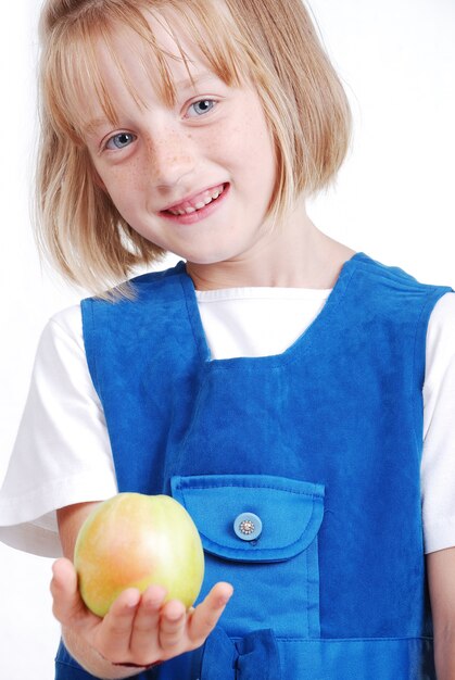 Une fille très mignonne, mangeant une pomme isolée