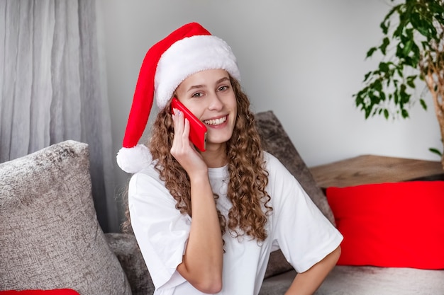 Fille utilisant un téléphone portable pour les félicitations de Noël