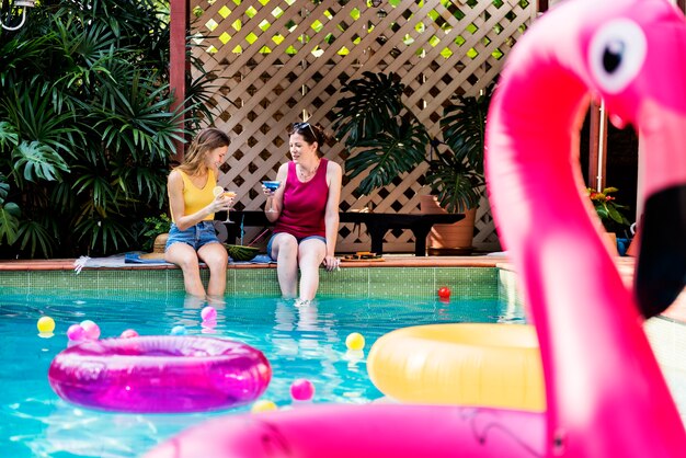 Filles se détendre au bord de la piscine