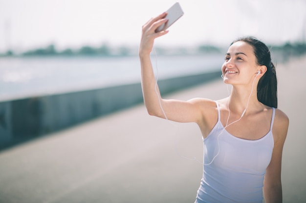 Fitness femmes exerçant et étirant en plein air et faisant selfie